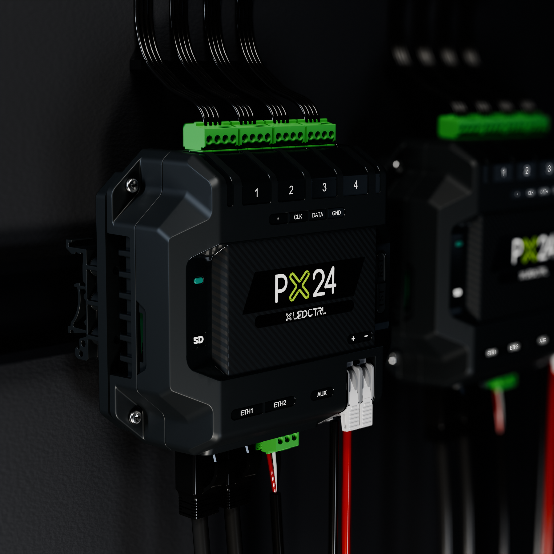 Two PX24 Pixel Controllers on DIN rail inside a dark equipment cabinet, pixel output terminal blocks wired along the top edge and ETH1, ETH2, AUX and power along the bottom